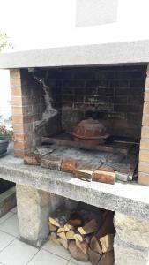 a brick oven with a pizza inside of it at Studio Laura in Ičići
