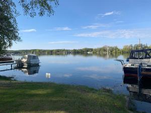 a couple of boats docked on a lake at Bungalow in Werder am Glindower See in Werder