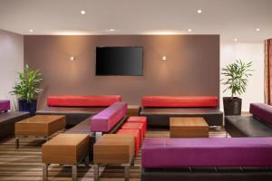 a living room filled with couches and chairs at Holiday Inn Express Poole, an IHG Hotel in Poole