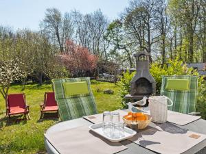 uma mesa e cadeiras com lareira num quintal em Elegant apartment with garden in Gingst em Gingst