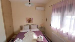 a small bedroom with a bed and a window at Panorama Xanthis in Xanthi