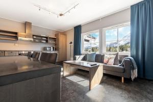 a kitchen and living room with a couch and a table at Hemsedal Cafe Skiers Lodge in Hemsedal