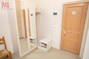 a dressing room with a mirror and a toilet at Гостиница Русь in Barnaul