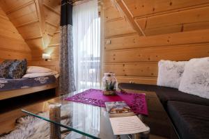a living room with a couch and a table at Domki Dream House Resort 606-436-626 in Poronin +184 photos