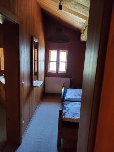 a room with a bed and a window in a house at Das Waldlerhaus in Lam