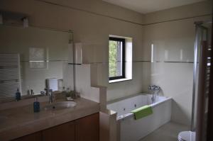 セヴェル・ド・ヴォウガにあるQuinta Porto dos Lobosのバスルーム(バスタブ、シンク付)、窓が備わります。