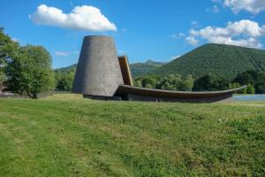 a smoke stack on a field with a mountain in the background at Hôtel ibis Styles Clermont-Ferrand Gare in Clermont-Ferrand