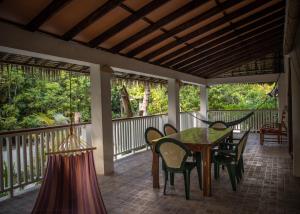 a patio with a table and chairs on a porch at AABANA Beach & Watersport Resort in Malapascua Island