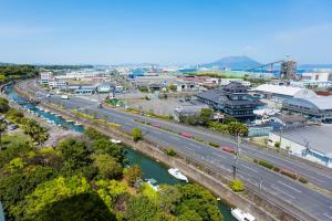 an aerial view of a city with a highway and a river at Kagoshima Coconuts Resort Marina (Love Hotel) in Kagoshima