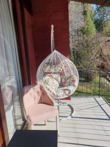 a porch with two chairs and a swing at Agape Glamping in Velika Remeta