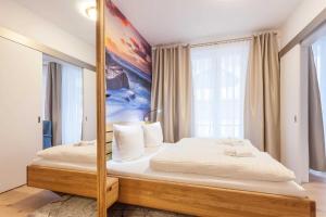 a bedroom with a bed with a large mirror at FIRST Wellentraum in Ostseebad Sellin