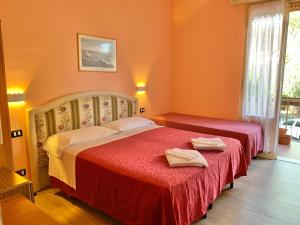 Postel nebo postele na pokoji v ubytování Albergo Cinzia