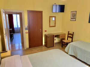 Postel nebo postele na pokoji v ubytování Albergo Cinzia