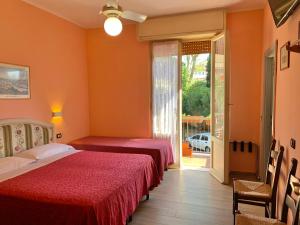 Postel nebo postele na pokoji v ubytování Albergo Cinzia
