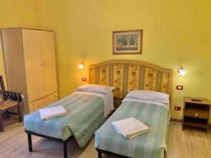 Postel nebo postele na pokoji v ubytování Albergo Cinzia