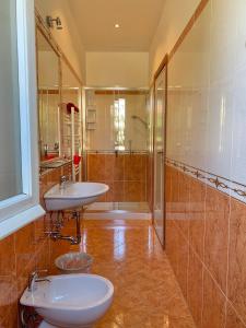 a bathroom with two sinks and a shower at Albergo Cinzia in Florence