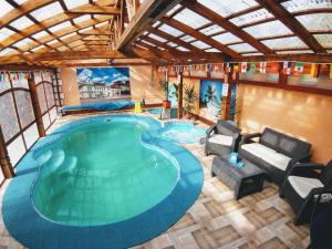 an overhead view of a large swimming pool in a building at Villa Magnat in Berehove