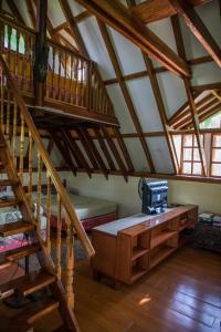 a attic room with a wooden staircase and a desk at AABANA Beach & Watersport Resort in Malapascua Island