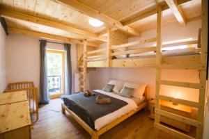 a bedroom with a bunk bed and a ladder at Chata Tatransky Medved in Demanovska Dolina