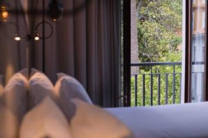 a bed room with a window and curtains at Azoris Angra Garden – Plaza Hotel in Angra do Heroísmo
