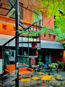 a group of tables and chairs in front of a building at 12th Avenue in Lahore