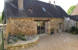 a stone building with a patio in front of it at La Vigne de Roger in Fleurac