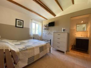 a bedroom with a bed and a dresser and a sink at Casa Cologna B&B in Roseto degli Abruzzi