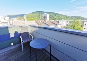a blue chair sitting on a balcony with a view at CF15 75m2 Central Duplex with AC and Balcony in Heidelberg