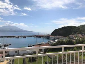 a view of a harbor with boats in the water at Azoris Faial Garden – Resort Hotel in Horta