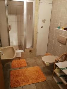 ein Bad mit einem Waschbecken, einem WC und einer Dusche in der Unterkunft Haus Janschütz in Flattach