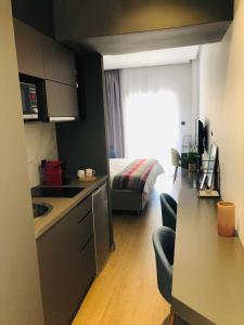 a small kitchen and living room with a bed at Metropolitan Complex Suite Faliro in Piraeus