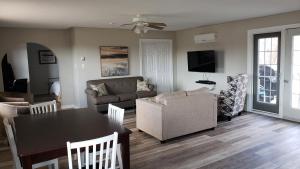 a living room with a couch and a table at Middleton Motel & Suites in Middleton