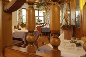 a dining room with tables and chairs and windows at Hotel - Restaurant Eberlwirt in Bruckberg