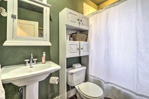 a bathroom with a white sink and a toilet at Charming Home in Downtown Nampa with Patio and Yard! in Nampa +18 photos