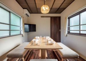 a dining room with a wooden table and chairs at Kanazawa - Apartment / Vacation STAY 80425 in Kanazawa