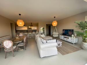 a living room with a white couch and a table at Almaza bay Beach Town Chalet in Marsa Matruh