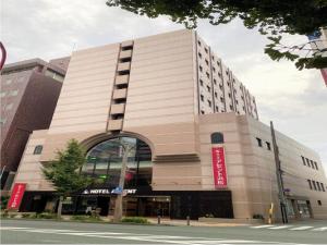 a large building with a red sign on it at Hotel Ascent Hamamatsu / Vacation STAY 79774 in Hamamatsu