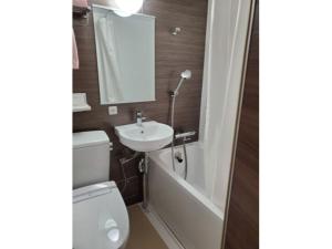 a bathroom with a toilet and a sink and a bath tub at Hotel Ascent Hamamatsu / Vacation STAY 79771 in Hamamatsu