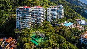 an aerial view of two tall buildings in a forest at AVALON - 1002 Amapas Bay Bliss with Private Pool in Puerto Vallarta