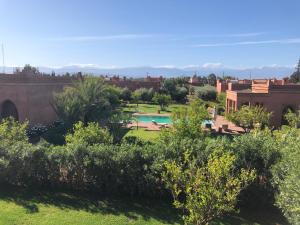 a view from the garden of a resort with a swimming pool at Domaine Casa Cecilia in Marrakech