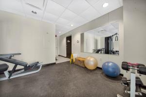 a room with a gym with a mirror and exercise equipment at Peninsula Island Resort & Spa - Beachfront Property at South Padre Island in South Padre Island