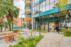 a building with tables and chairs in front of it at Selina Madalena Sao Paulo in Sao Paulo