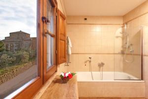 a bathroom with a tub and a sink at Sovana Hotel & Resort in Sovana