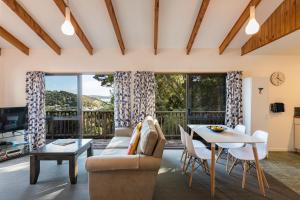 a living room with a couch and a table at Allure Lodge in Paihia