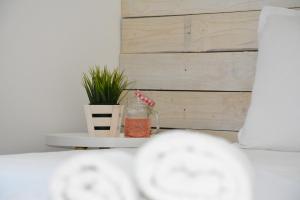 a table with a plant in a room with a wall at Milennia Family Hotel in Sunny Beach