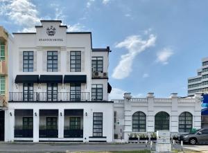 un edificio blanco con un cartel. en Stanton Hotel, en Kota Kinabalu