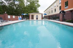 a large blue swimming pool next to a building at Holiday Inn Express Minden by IHG in Minden