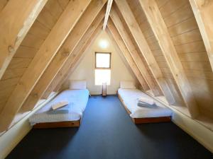 a room with two beds in the attic at Snowdragon in Dinner Plain