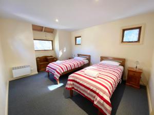 a room with two beds in a room at Snowdragon in Dinner Plain +2 photos