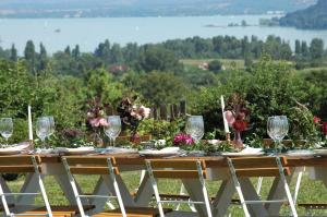 a wooden table with wine glasses and flowers on it at Koczor Winery & Guesthouse in Balatonfüred